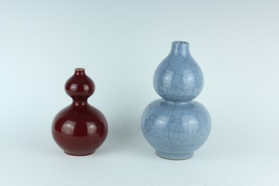 Lot 163 - Two Chinese monochrome double-gourd vases,...