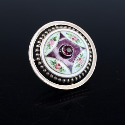 Lot 2021 - A white metal circular button, featuring a...