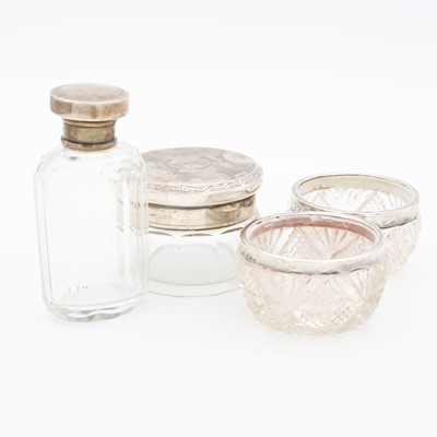 Lot 228 - A collection of four silver topped cut glass...