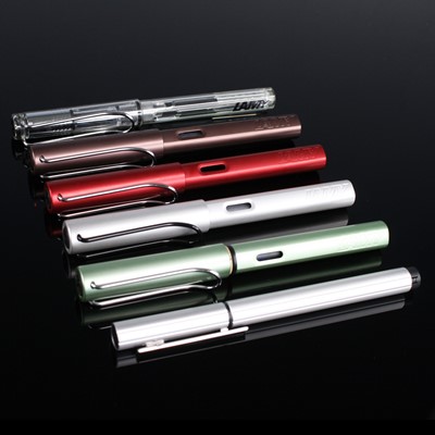 Lot 412 - A collection of thirteen Lamy fountain pens,...