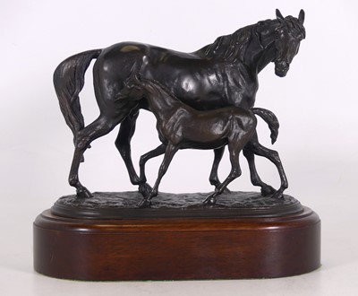Lot 27 - A reproduction bronze figure group of a horse...