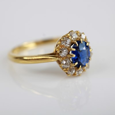 Lot 2037 - A yellow metal, sapphire and diamond oval...