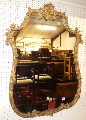 Lot 1156 - A floral gilt moulded shaped wall mirror, in...