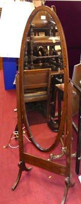 Lot 1194 - An early 20th century oak oval cheval mirror