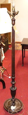 Lot 1199 - An early 20th century fluted oak standard lamp,...