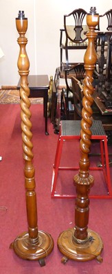 Lot 1200 - Two similar spiral turned teak standard lamps