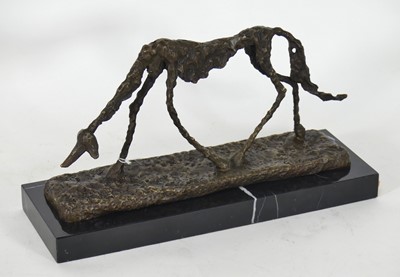 Lot 126 - A reproduction bronze figure of a dog, in the...