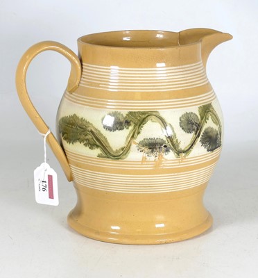 Lot 176 - A 19th century mochaware jug, decorated with a...