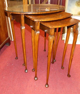 Lot 1218 - A figured walnut and crossbanded oval nest of...