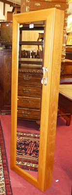 Lot 1234 - A contemporary blond oak effect hanging...