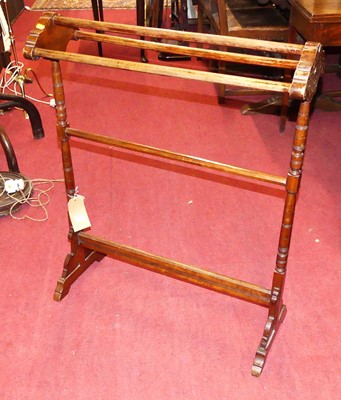 Lot 1243 - An Edwardian walnut towel rail, of ring-turned...