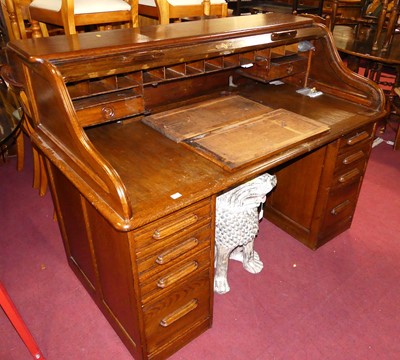 Lot 1278 - A 1930s oak roll top kneehole writing desk,...