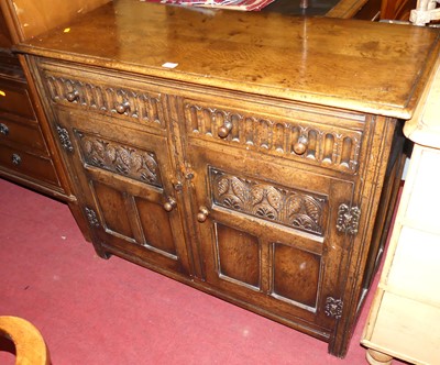 Lot 1263 - A joined oak double-door side cupboard, in the...