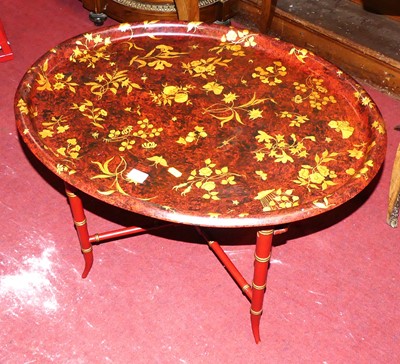 Lot 1266 - A red and gilt lacquered oval occasional table...