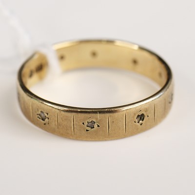 Lot 298 - A 9ct gold and diamond point set band ring,...