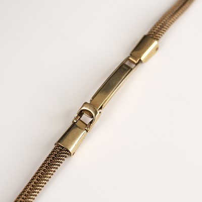 Lot 302 - A lady's 9ct gold solid and meshlink watch...
