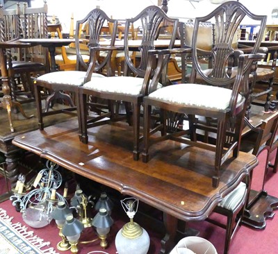 Lot 1291 - A walnut shaped top trestle end dining table,...