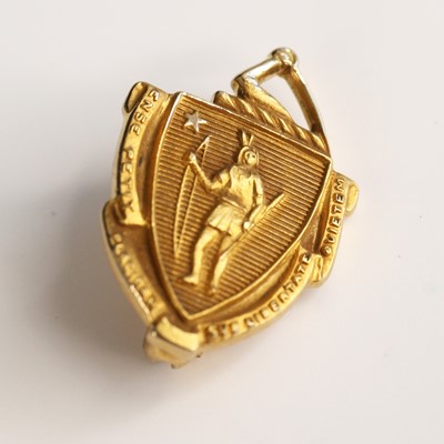 Lot 310 - A yellow metal shield shaped armorial brooch,...