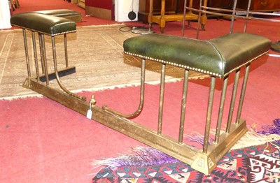 Lot 1295 - A brass club fender having studded green...