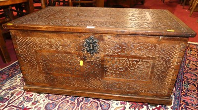 Lot 1307 - An Eastern stained hard wood and relief carved...