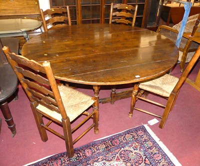 Lot 1308 - A joined oak drop leaf double gateleg dining...