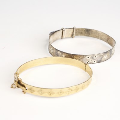 Lot 337 - A rolled gold hinged bangle; together with a...