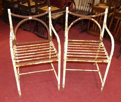 Lot 1353 - A pair of painted iron strapwork garden elbow...