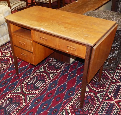 Lot 1375 - A 1960s teak kneehole writing desk, having...