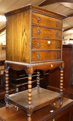Lot 1400 - A 1920s oak four-drawer music chest, having...