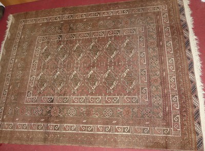 Lot 1411 - A Persian woollen brown ground Bokhara rug,...