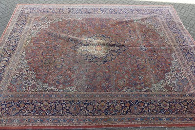 Lot 1418 - A Persian woollen red, blue and cream ground...
