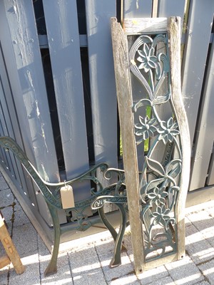 Lot 1431 - A green painted iron garden bench, raised on...