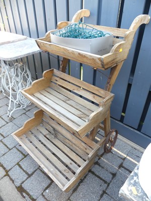 Lot 1435 - A pine three-tier wheeled plant trolley, width...