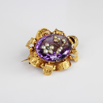 Lot 2038 - A yellow metal amethyst brooch, featuring an...