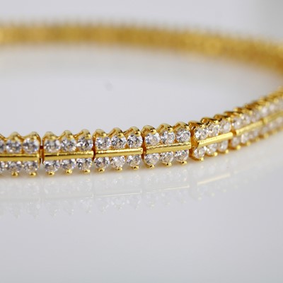 Lot 140 - A yellow metal tennis bracelet, set with 216 1....