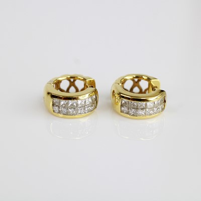 Lot 2045 - A pair of yellow metal diamond huggy hoop...