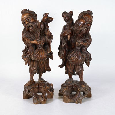 Lot 5 - A pair of Chinese carved hardwood figures of...