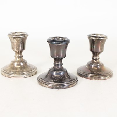 Lot 257 - A set of three silver squat table candlesticks,...