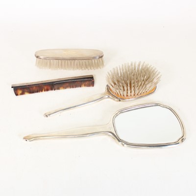 Lot 291 - An Art Deco style four-piece silver-backed...