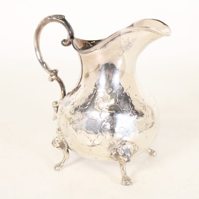 Lot 241 - A white metal cream jug, of squat bulbous form...