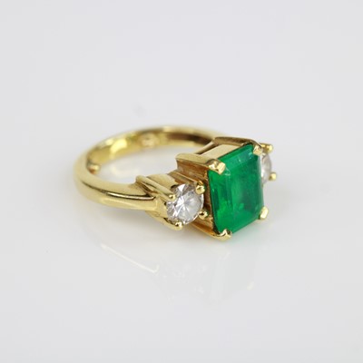 Lot 2052 - A yellow metal emerald and diamond 3 stone...