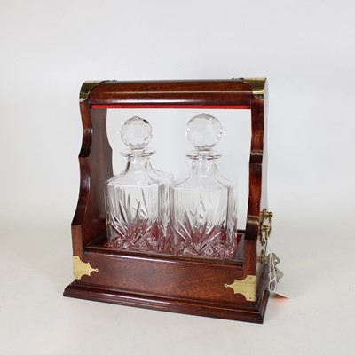 Lot 16 - A reproduction brass mounted mahogany tantalus,...
