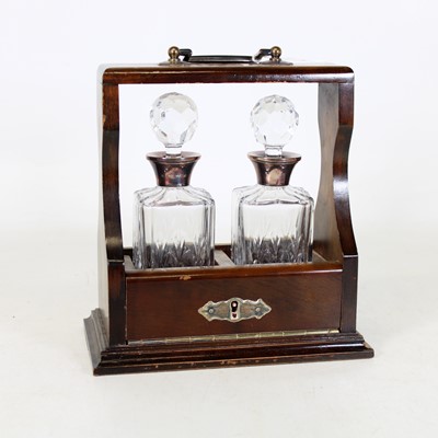 Lot 17 - A reproduction mahogany tantalus, of small...