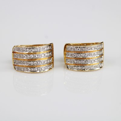 Lot 2086 - A pair of yellow metal diamond huggy hoop...
