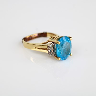 Lot 2096 - A yellow metal, blue topaz and diamond dress...