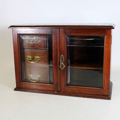 Lot 27 - An Edwardian walnut smoker's cabinet, the twin...
