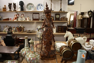 Lot 44 - An oriental carved hardwood figure of a deity,...