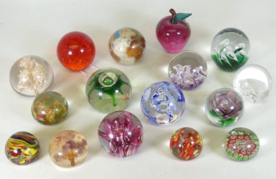 Lot 77 - A collection of glass paperweights, to include...