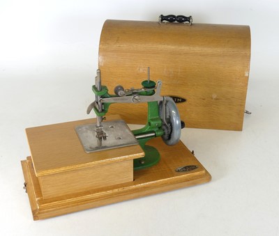Lot 186 - A Grain child's sewing machine and cover
