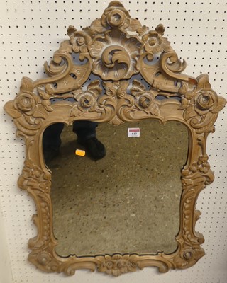 Lot 513 - A carved and limed beech wood wall mirror in...